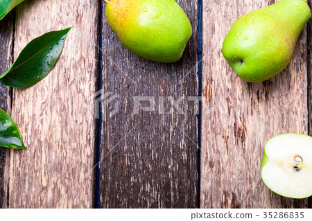 Pear on wooden rustic background. Top view. Pear on wooden rustic background. Top view. 35286835
