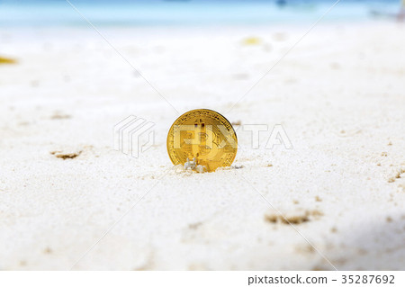 Golden Bitcoins on a beach sand 35287692
