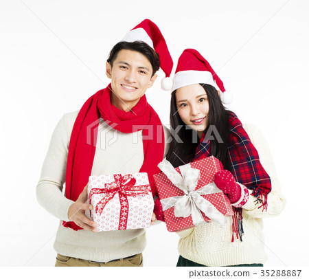 happy young couple showing christmas gifts 35288887