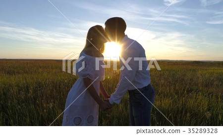 Young beautiful couple in a wheat field Young beautiful couple in a wheat field 35289328