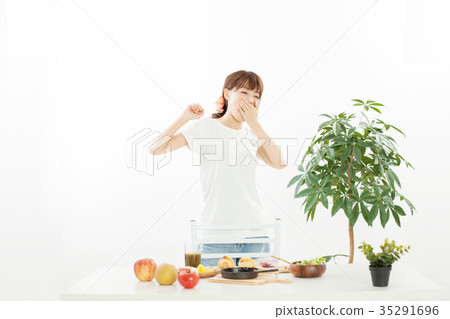 A young woman eating breakfast A young woman eating breakfast 35291696