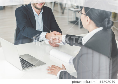Happy female shaking man hand Happy female shaking man hand 35292019