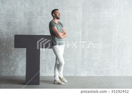 Pleasant trendy young man is expressing rejoicing Pleasant trendy young man is expressing rejoicing 35292452