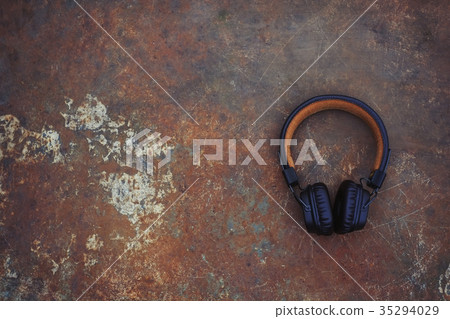 brown wireless headphones with a wire background 35294029