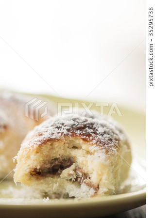 Closeup baked rolls with coconut on the plate Closeup baked rolls with coconut on the plate 35295738