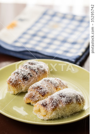 Homemade rolls with coconut served on the plate Homemade rolls with coconut served on the plate 35295742