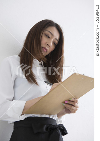 A woman taking a note A woman taking a note 35298413