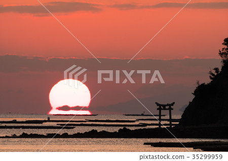 Daruma Asahi rising from an island with a torii in the Seto Inland Sea Daruma Asahi rising from an island with a torii in the Seto Inland Sea 35299959