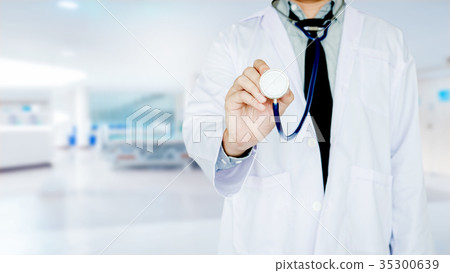 Doctor holding a stethoscope on Hospital ward Doctor holding a stethoscope on Hospital ward 35300639