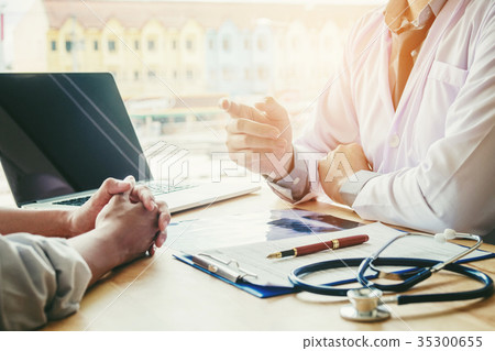 Doctors and patients sit and talk. At the table Doctors and patients sit and talk. At the table 35300655
