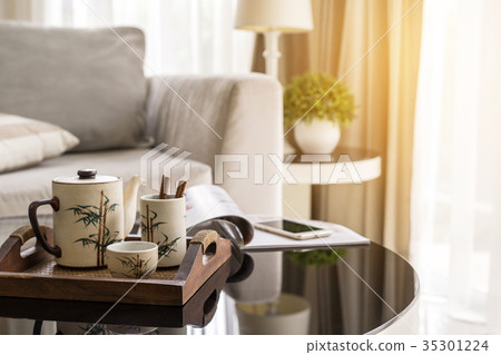 cup of tea on wooden tray on a round table 35301224