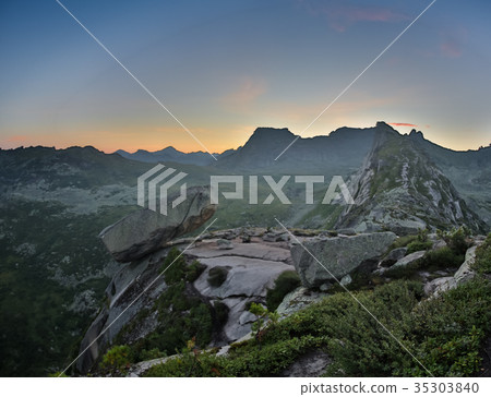 Hanging stone lies on sloping surface of mountain Hanging stone lies on sloping surface of mountain 35303840