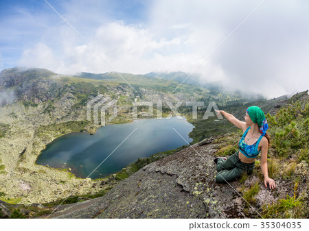 Girl enjoy a beautiful mountain lake, in the Girl enjoy a beautiful mountain lake, in the 35304035