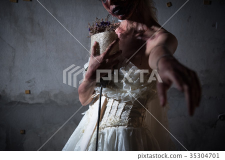 Bride Zombie in wedding dress with dried flowers pointing and wa 35304701