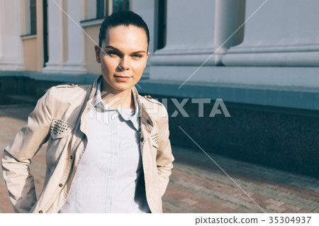 Portrait of a young pretty girl in a beige jacket 35304937
