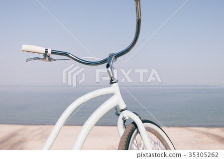 Close-up of a blue retro bicycle against the sea Close-up of a blue retro bicycle against the sea 35305262