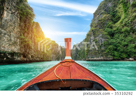 Long-tail wooden boat sailing on Pileh lagoon Long-tail wooden boat sailing on Pileh lagoon 35310292