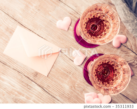 Two pink champagne glasses with blank paper  35311933