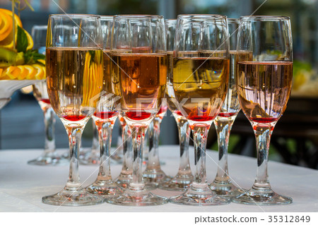 glasses with champagne and fruits 35312849