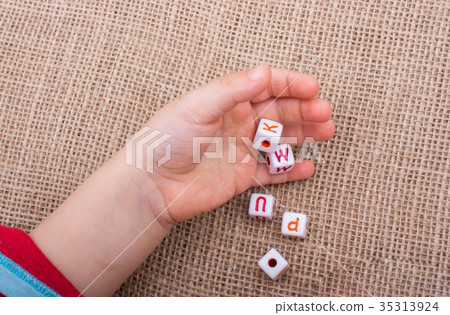 Colorful alphabet letter cubes in hand Colorful alphabet letter cubes in hand 35313924