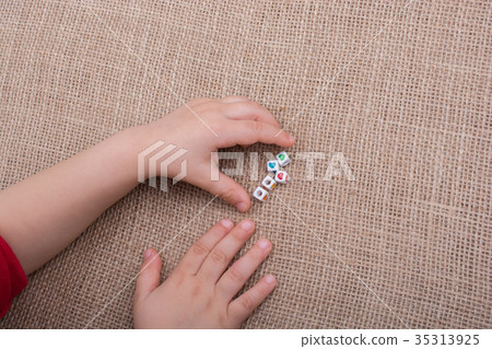 Cubes with heart shape in hand on canvas Cubes with heart shape in hand on canvas 35313925