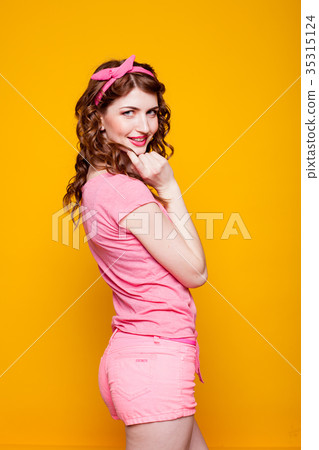 girl pinup-style in a pink dress 35315124