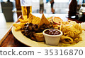 Unhealthy meal with mexican nacho chips loaded 35316870