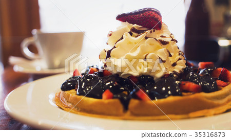 Delicious homemade waffle desert with fruits and Delicious homemade waffle desert with fruits and 35316873