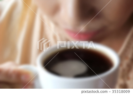 blurry photo of woman drinking coffee 35318009