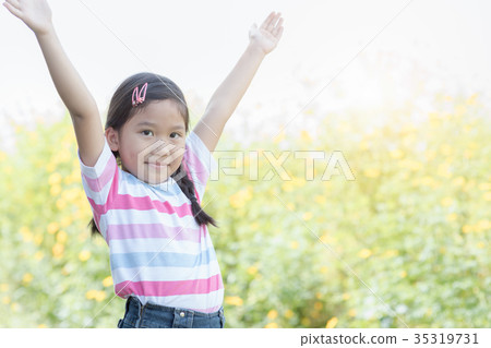 Happy cute girl smiling woman in flower field Happy cute girl smiling woman in flower field 35319731