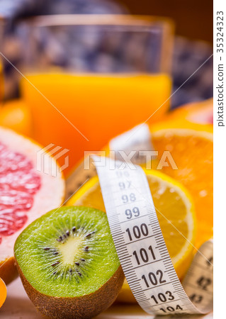Measure tape and fresh citrus fruit orange lemon. 35324323