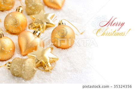 Christmas gold ornaments on the snow Christmas gold ornaments on the snow 35324356