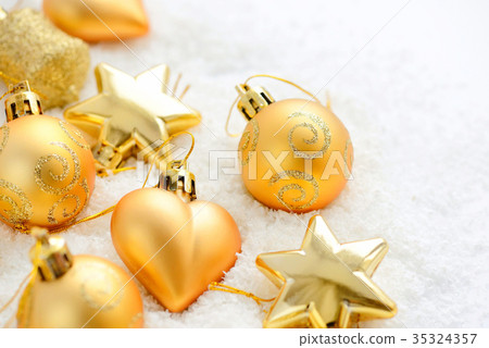 Christmas gold ornaments on the snow Christmas gold ornaments on the snow 35324357