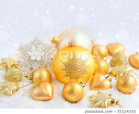 Christmas gold ornaments on the snow Christmas gold ornaments on the snow 35324358