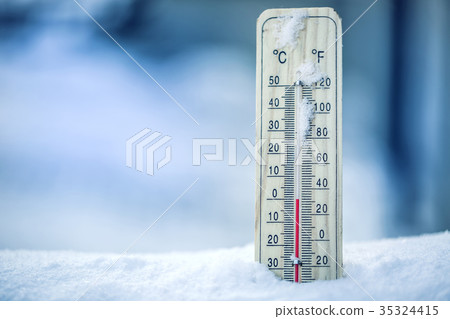 Thermometer on snow shows low temperatures. Thermometer on snow shows low temperatures. 35324415