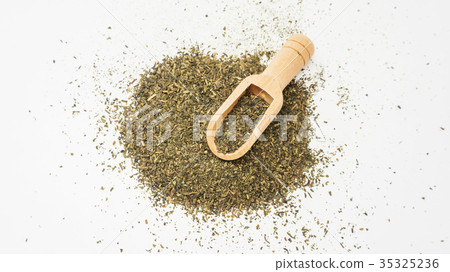 A green tea leaf on a white background. A green tea leaf on a white background. 35325236