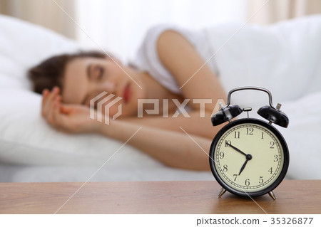 Beautiful sleeping woman resting in bed and trying Beautiful sleeping woman resting in bed and trying 35326877