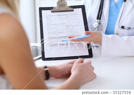 Close up of a doctor and  patient hands whil 35327559