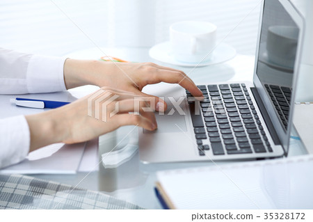 Close up of business woman hands typing on laptop Close up of business woman hands typing on laptop 35328172
