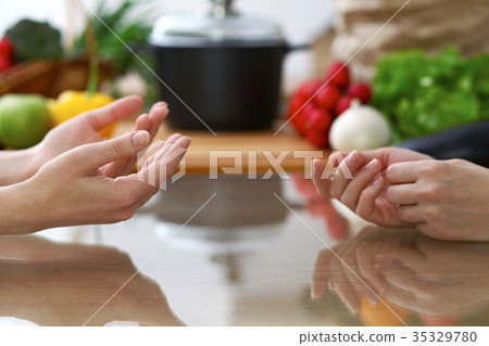 Close-up of human hands are gesticulate over a Close-up of human hands are gesticulate over a 35329780
