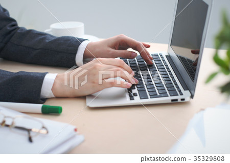 Close-up of business woman  hands  typing on  lap 35329808