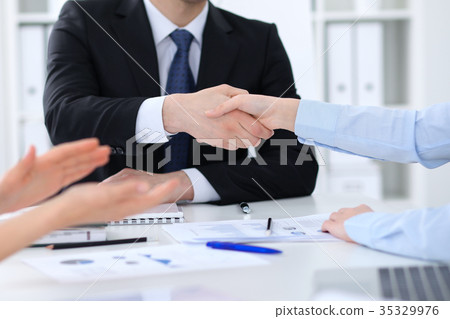 Business people shaking hands, finishing up a 35329976