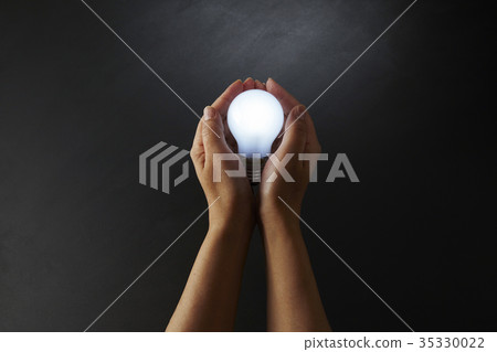 Adult female hand and light bulb Adult female hand and light bulb 35330022