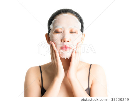 Young woman doing facial mask sheet 35330249