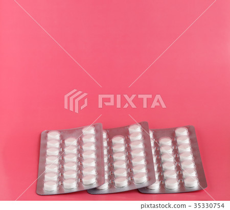 Three blister packs of white pills Three blister packs of white pills 35330754