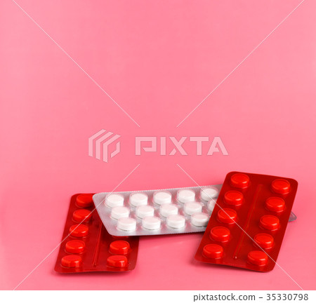 Red and white blister pack of white pills Red and white blister pack of white pills 35330798