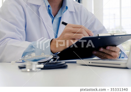 close up of patient and doctor taking notes  35331340