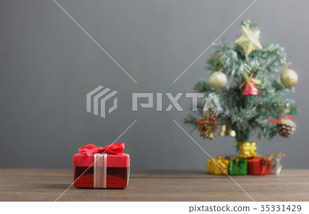 Red gift box and fir tree background. Red gift box and fir tree background. 35331429
