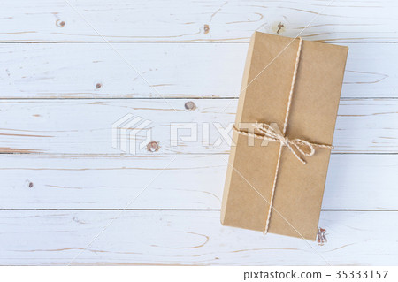 Top view above brown gift box on wooden Top view above brown gift box on wooden 35333157