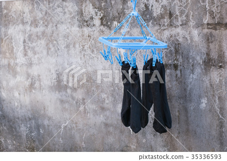 Clothes pegs or clothespins hang on a cord 35336593